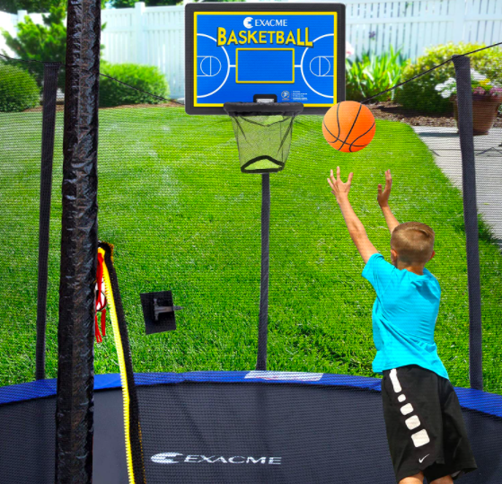 A child shooting a basketball into an Exacme basketball hoop