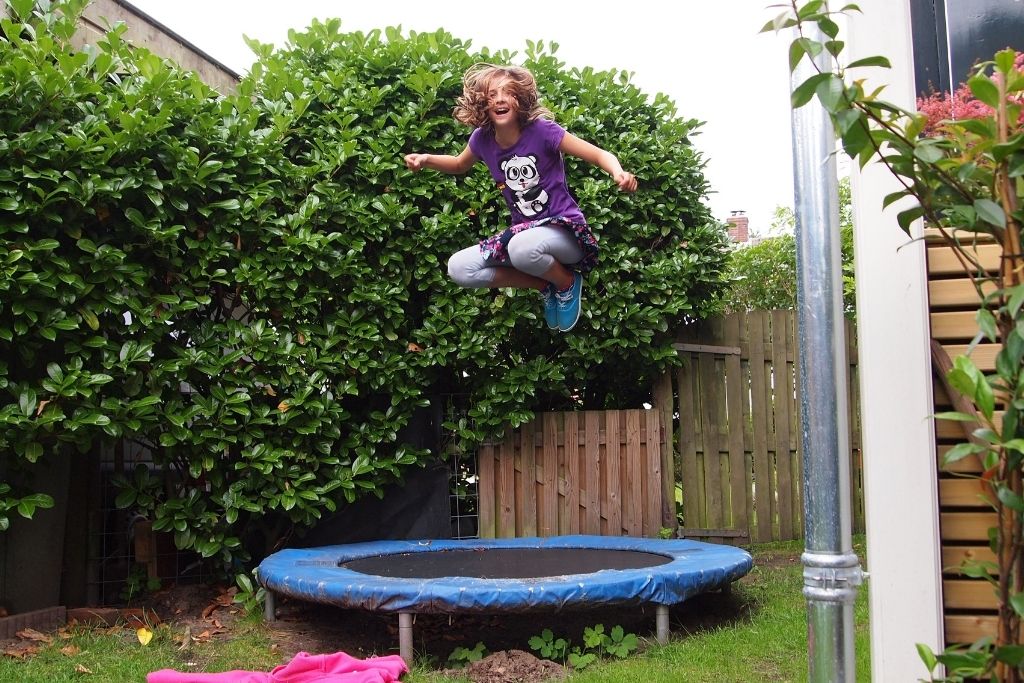 A Girl Jumping On A Trampoline.